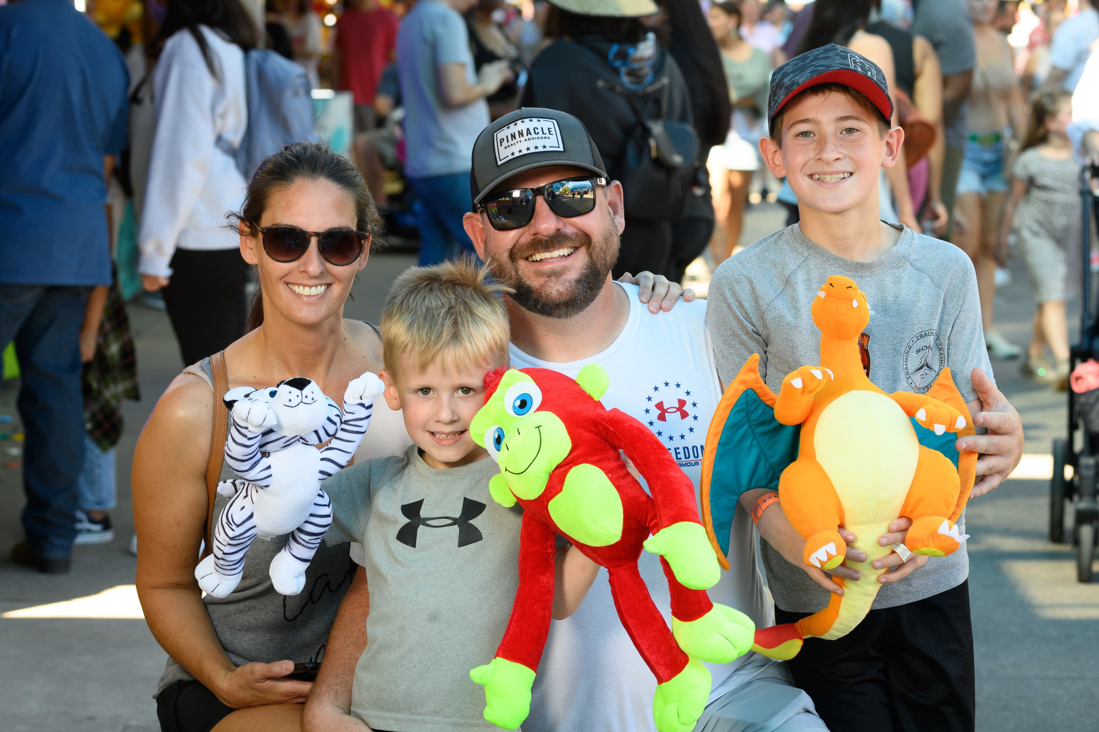 File photo: Fair visitors pose with stuffed animal prizes.